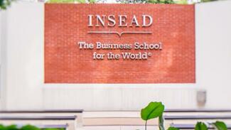 INSEAD Executive Education title and logo on a wall at a campus entrance