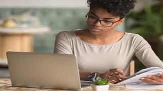 An international MSBM student carrying out her online studies on a laptop